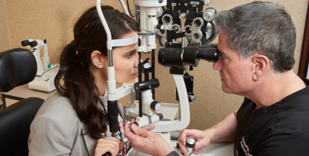 Dr. Sherman examining patient's eyes